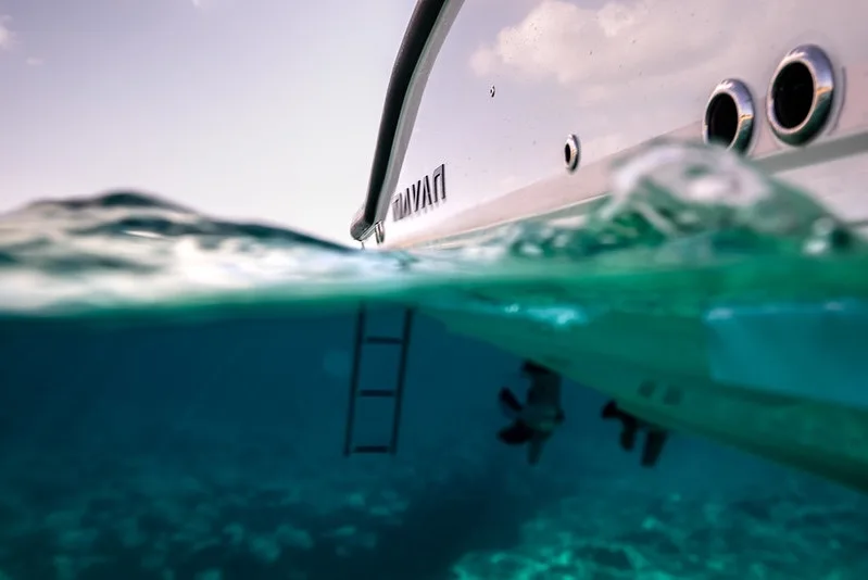 Boarding ladder and clear water at the stern of the NAVAN S30
