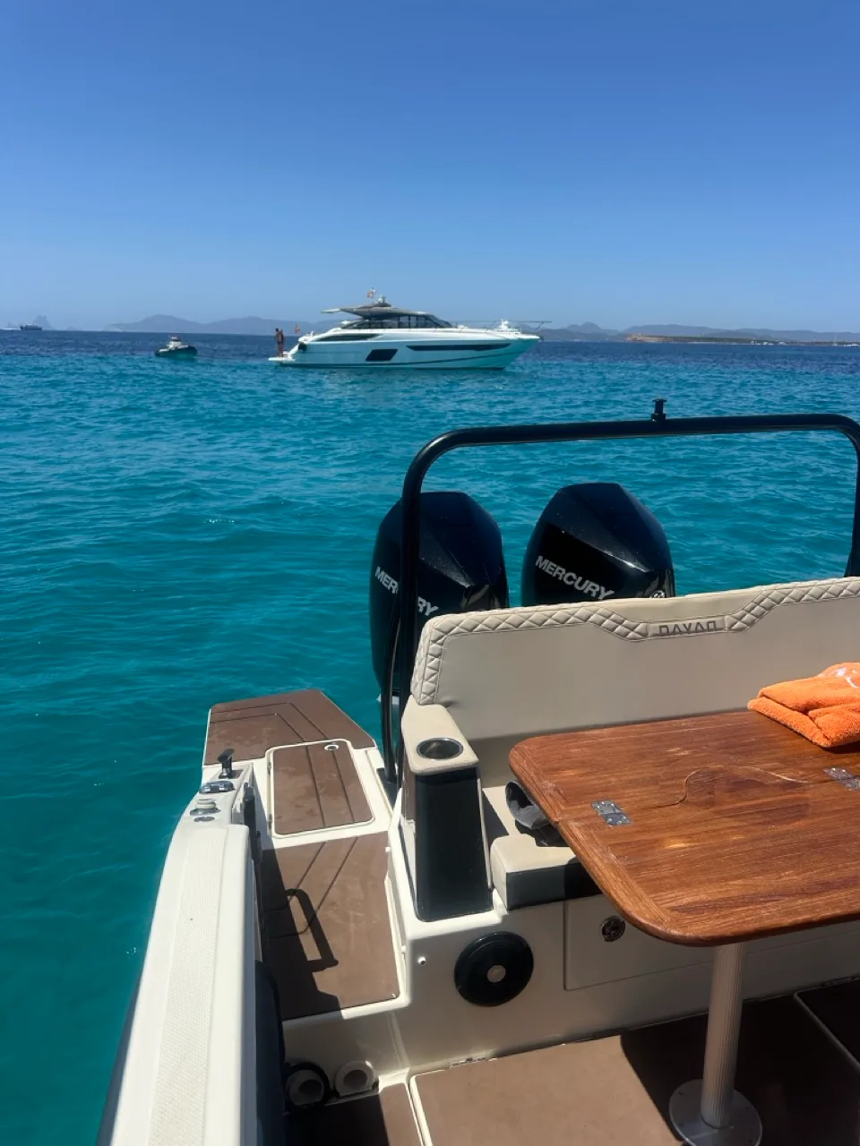 Aft deck of the NAVAN S30 at anchor in shallow, clear water off Formentera